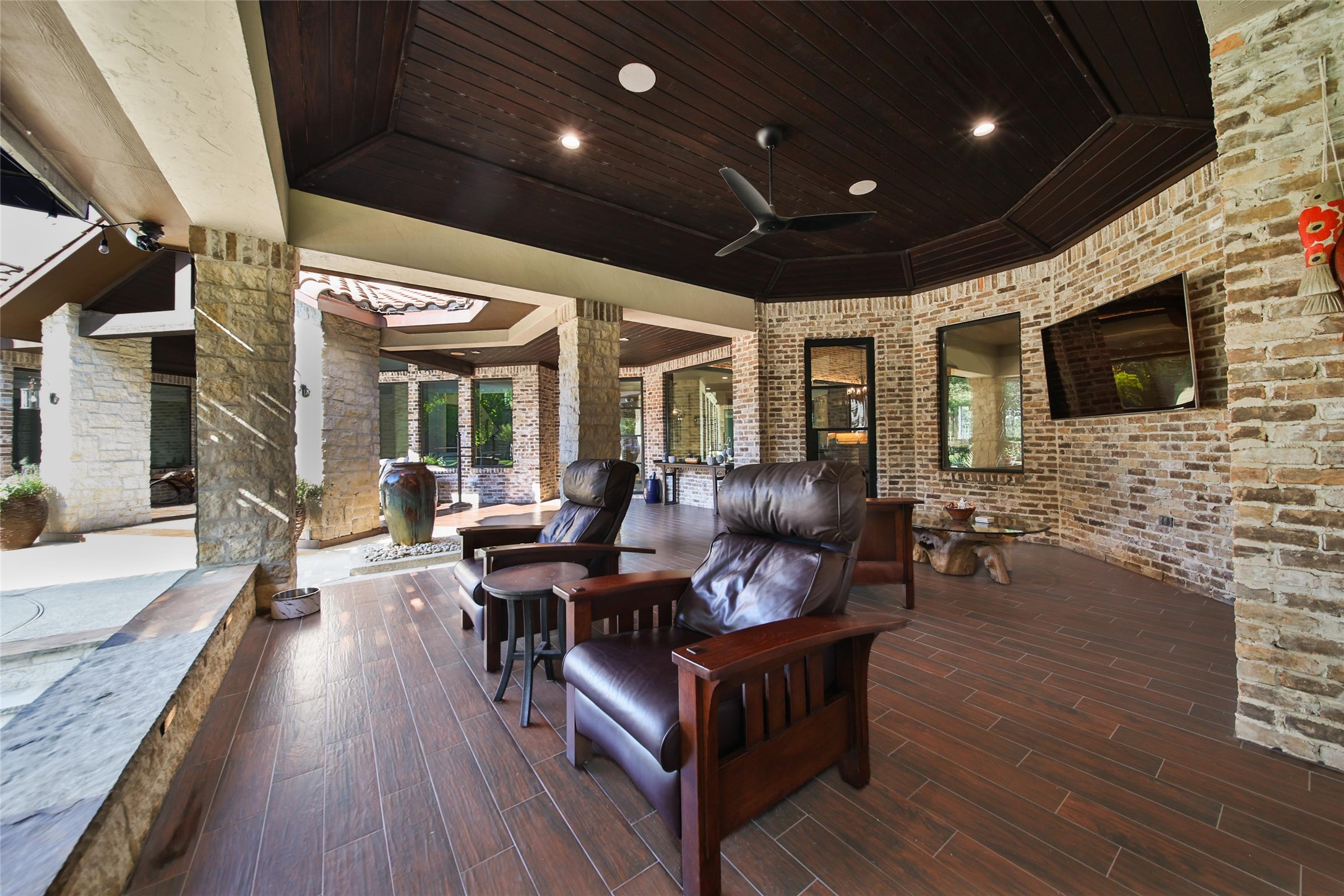 2 Highclere Park Drive Spring, TX 77379 - Photo 39 of 50 Enjoy game day lounging on the patio, designed for outdoor TV viewing or enjoy your favorite playlist utilizing surround sound throughout the home—including the patio and pool area—seamlessly controlled via the Savant system for the ultimate entertainment experience.