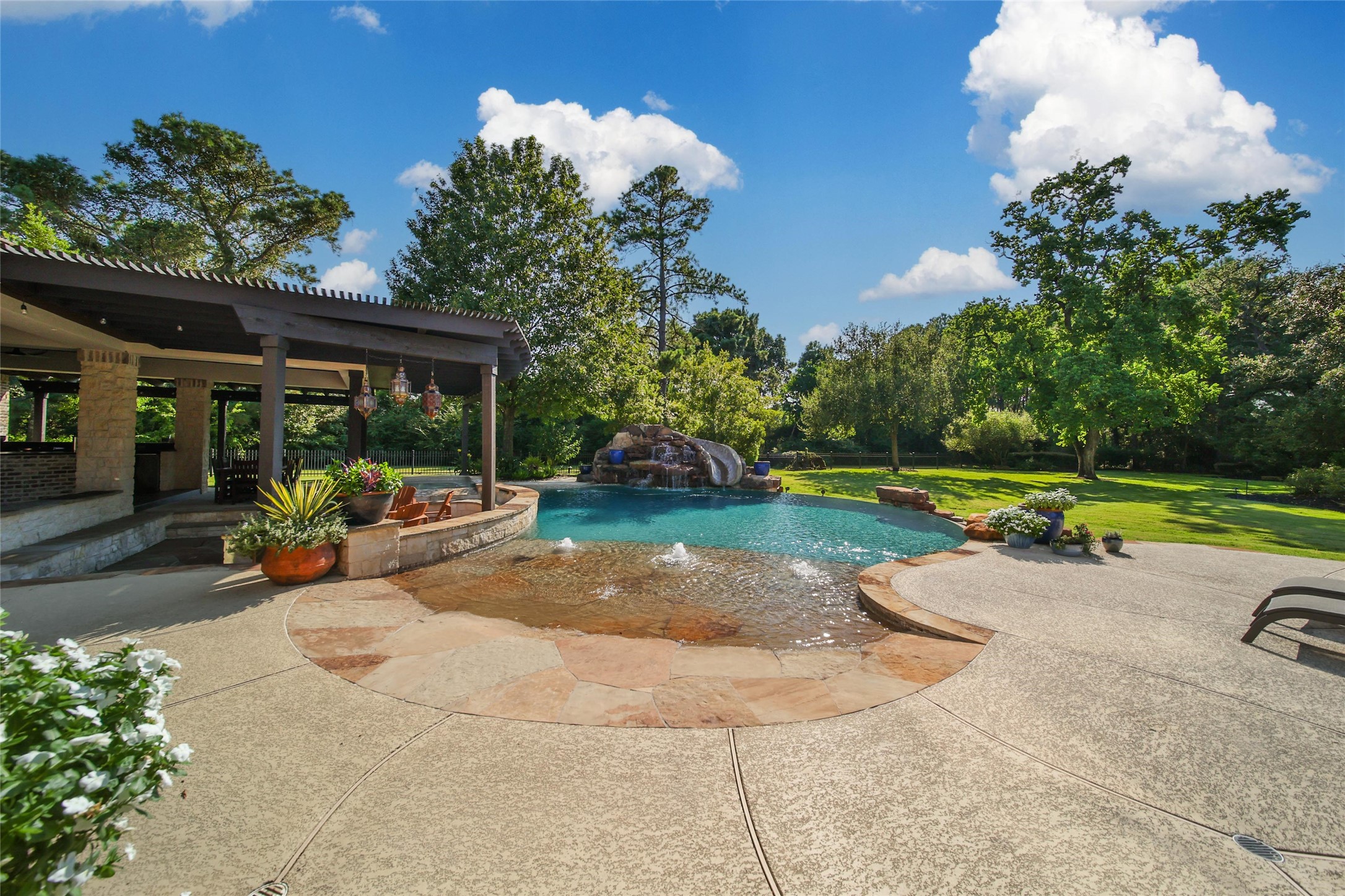 2 Highclere Park Drive Spring, TX 77379 - Photo 42 of 50 The resort-style beach entry pool with a rock waterfall and slide provides endless hours of summer fun! Easily control the pool features from your phone. And maintenance is a breeze with the robot pool cleaner.