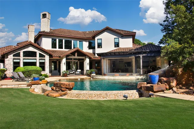 a front view of a house with swimming pool having outdoor seating