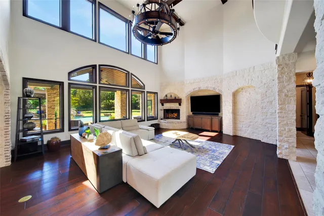 a living room with furniture fireplace and wooden floor