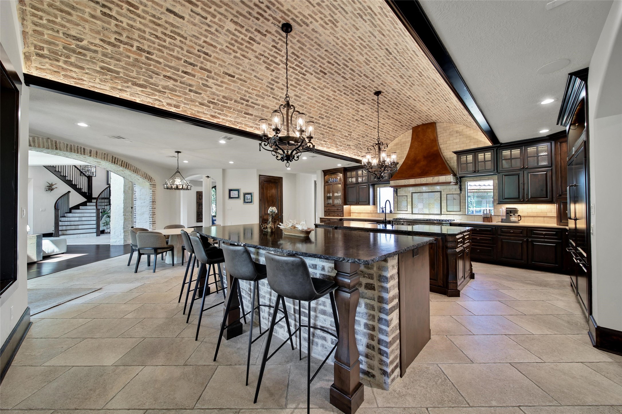 2 Highclere Park Drive Spring, TX 77379 - Photo 8 of 50 Natural textures and a striking barreled brick ceiling infuse this elegant home with timeless character.