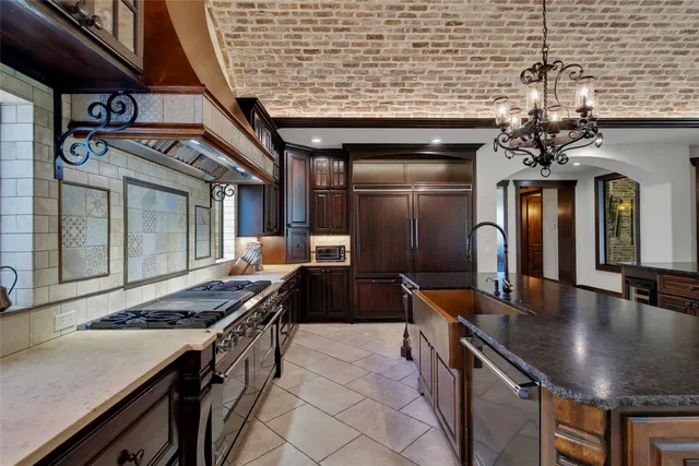 a kitchen with stainless steel appliances granite countertop a stove and a refrigerator
