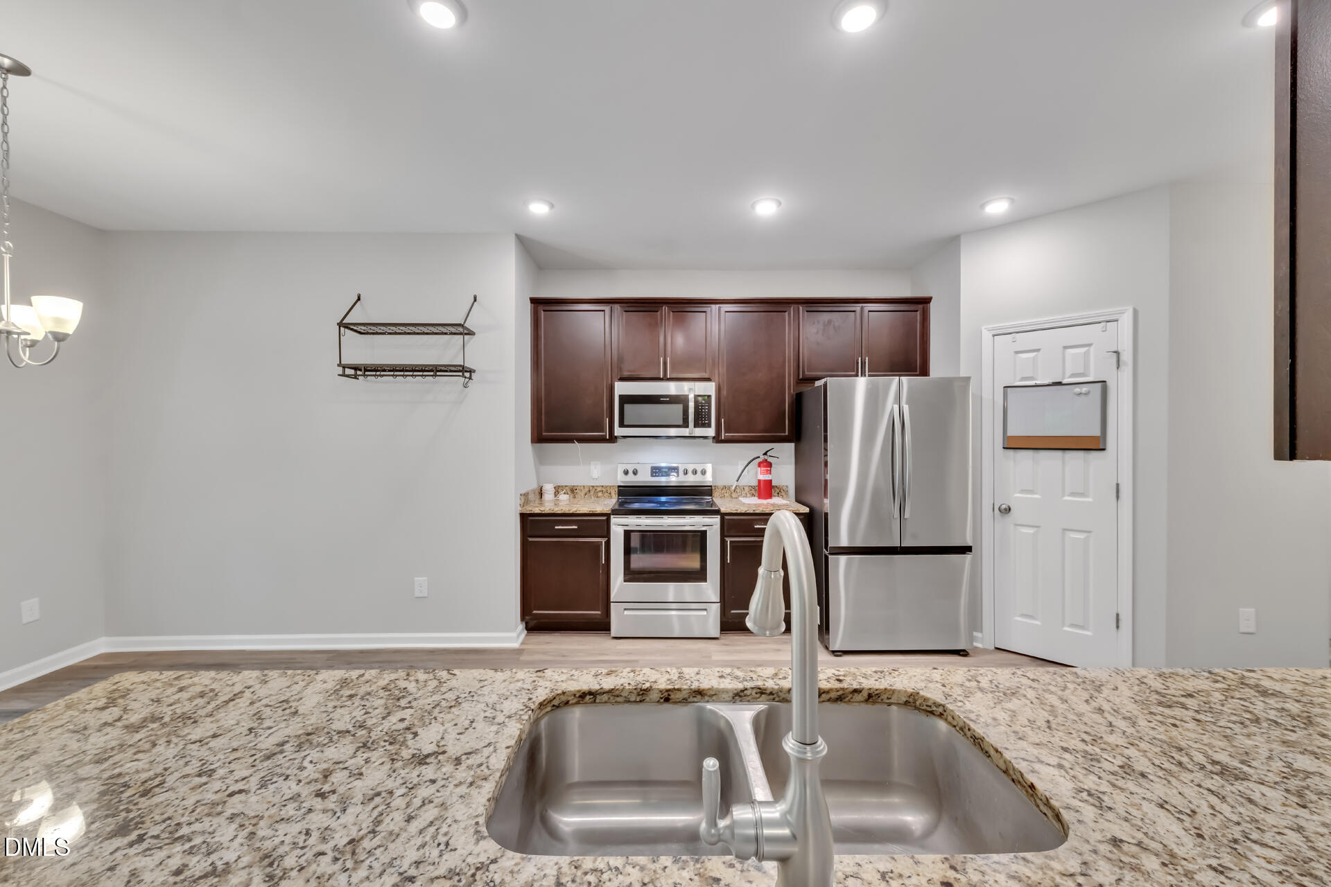 5317 Fayetteville Road, Unit A Durham, NC 27713 - Photo 17 of 50 a kitchen with kitchen island a sink stainless steel appliances and a counter top