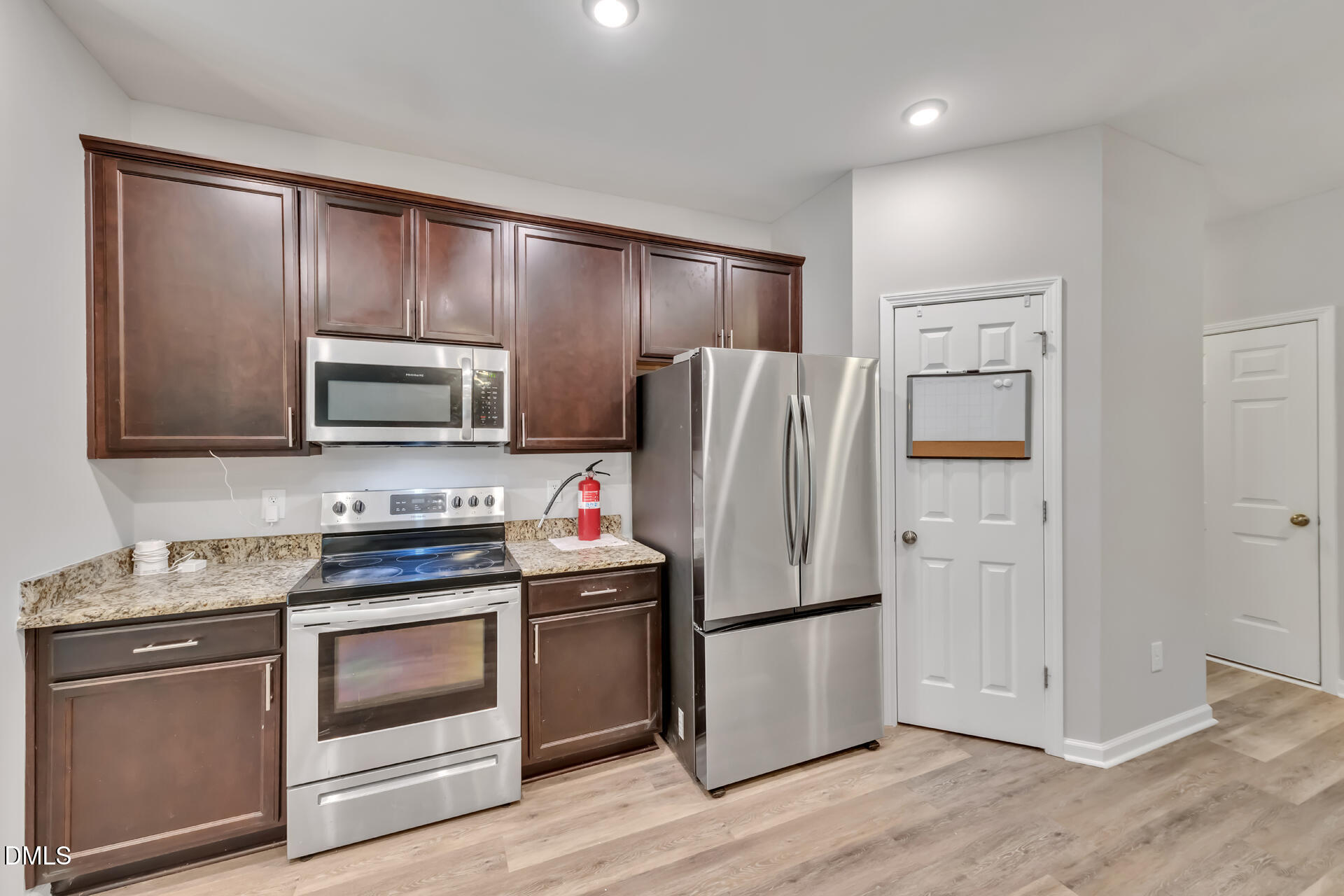 5317 Fayetteville Road, Unit A Durham, NC 27713 - Photo 18 of 50 a kitchen with stainless steel appliances a refrigerator stove and microwave