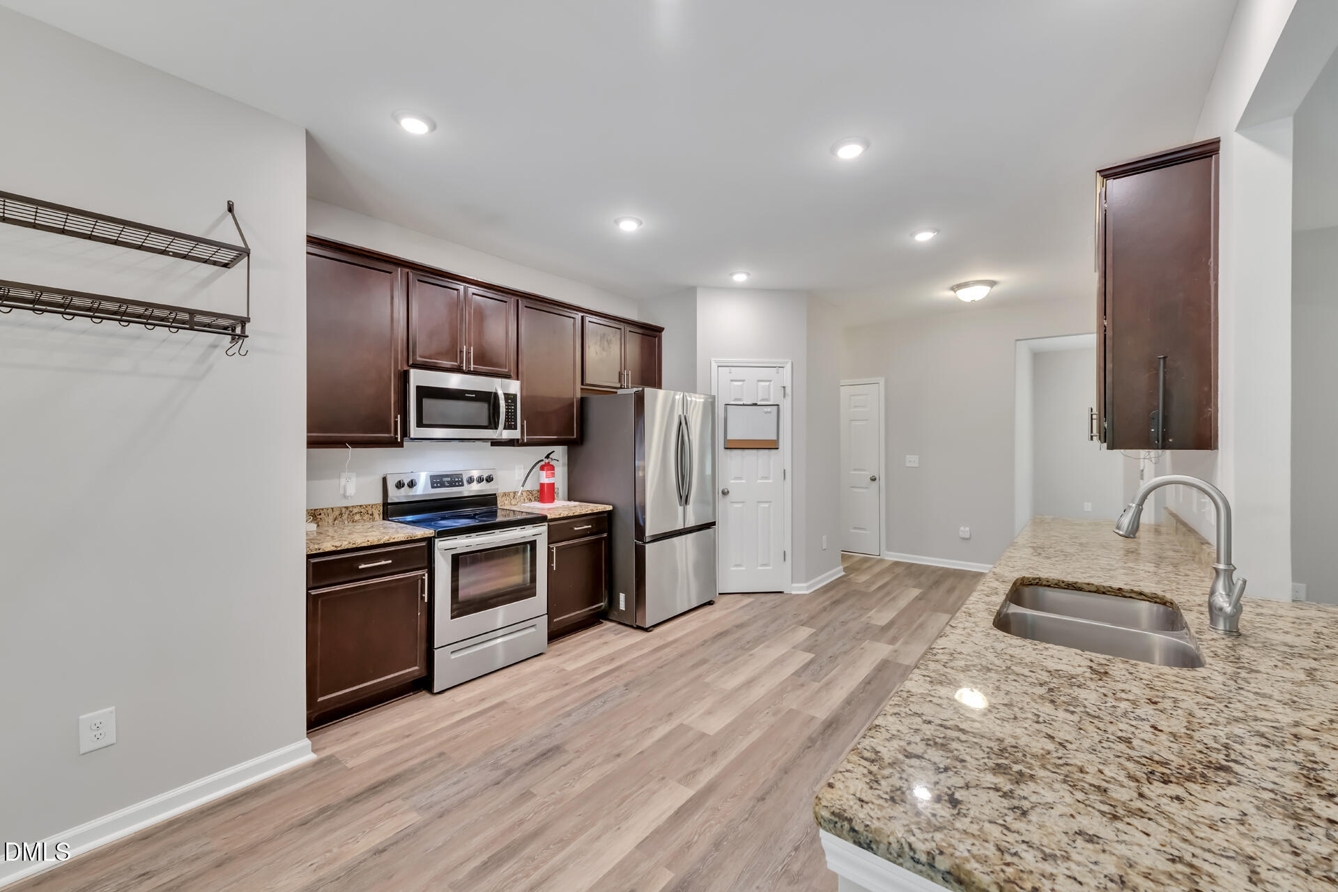 5317 Fayetteville Road, Unit A Durham, NC 27713 - Photo 20 of 50 a kitchen with kitchen island granite countertop stainless steel appliances and wooden cabinets