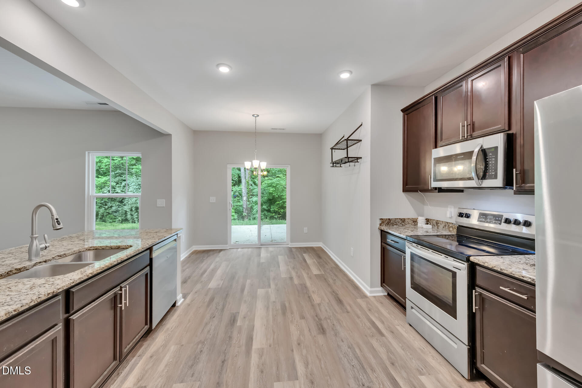 5317 Fayetteville Road, Unit A Durham, NC 27713 - Photo 21 of 50 a kitchen with stainless steel appliances a sink dishwasher a stove top oven a refrigerator with wooden floor and cabinets