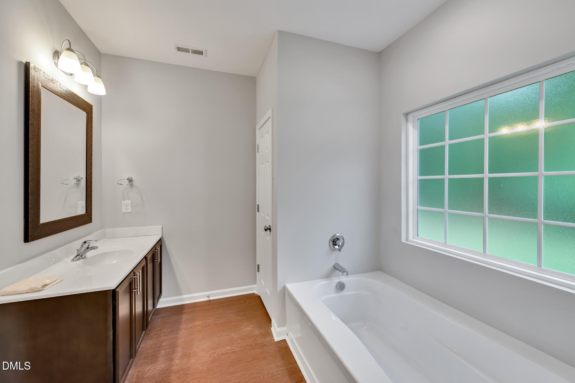 5317 Fayetteville Road, Unit A Durham, NC 27713 - Photo 33 of 50 a bathroom with a tub sink and mirror
