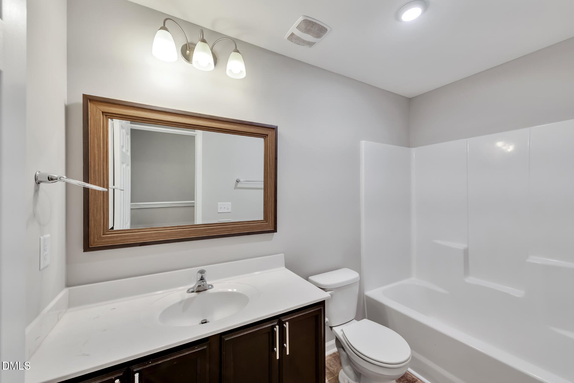 5317 Fayetteville Road, Unit A Durham, NC 27713 - Photo 45 of 50 a bathroom with a toilet a sink a bathtub and a mirror
