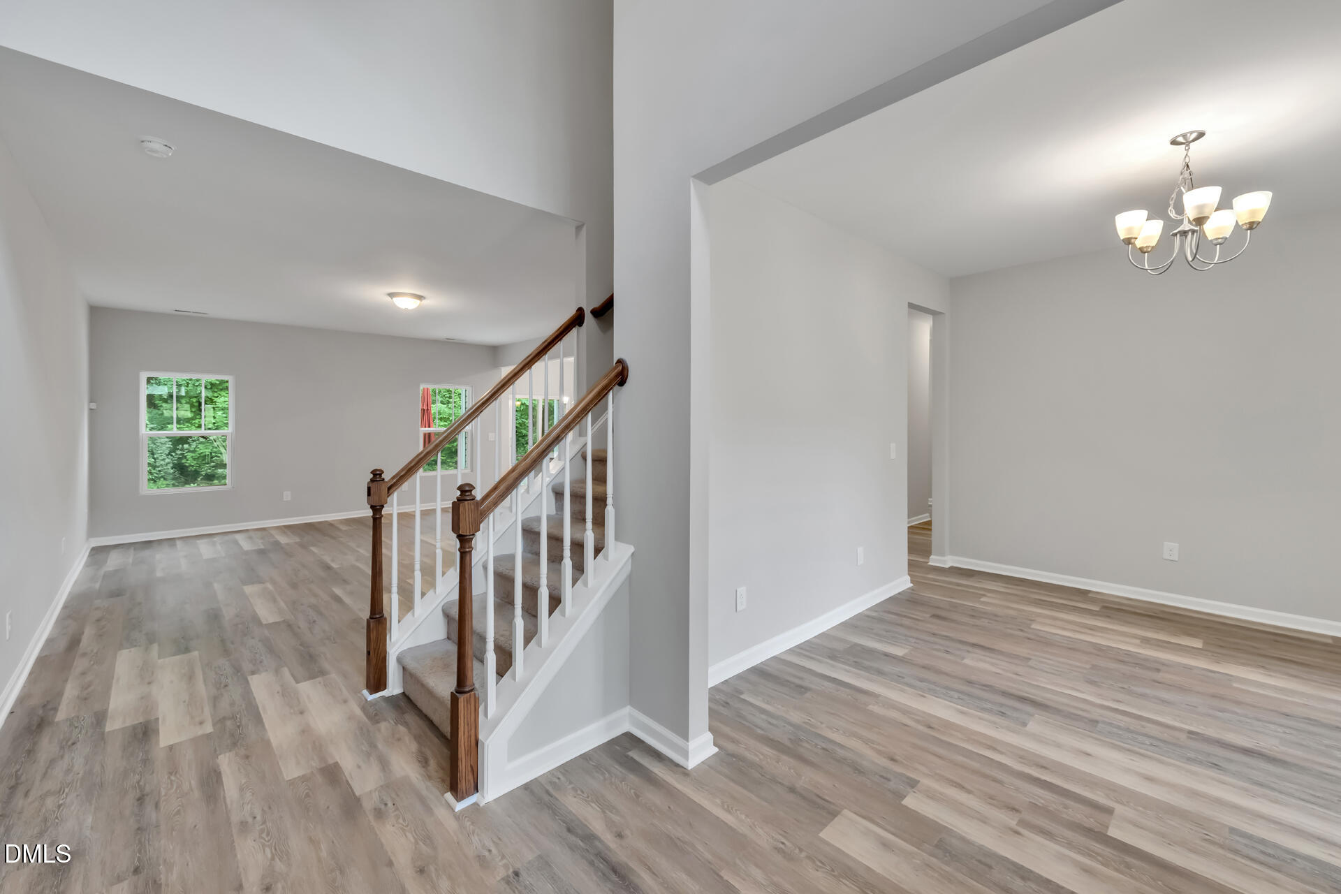 5317 Fayetteville Road, Unit A Durham, NC 27713 - Photo 9 of 50 a view of an empty room with wooden floor and stairs