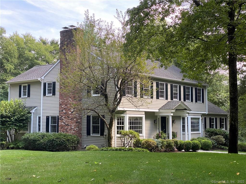 421 Thayer Pond Road Wilton, CT 06897 - Photo 1 of 1 a front view of a house with a garden