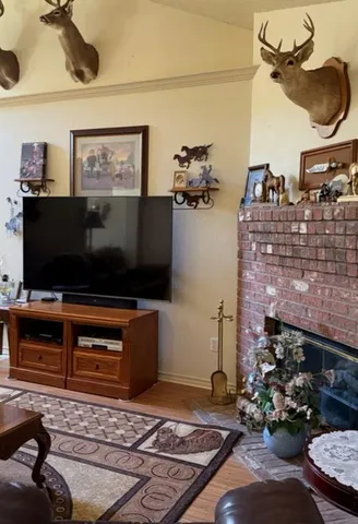 a living room with fireplace furniture and a flat screen tv