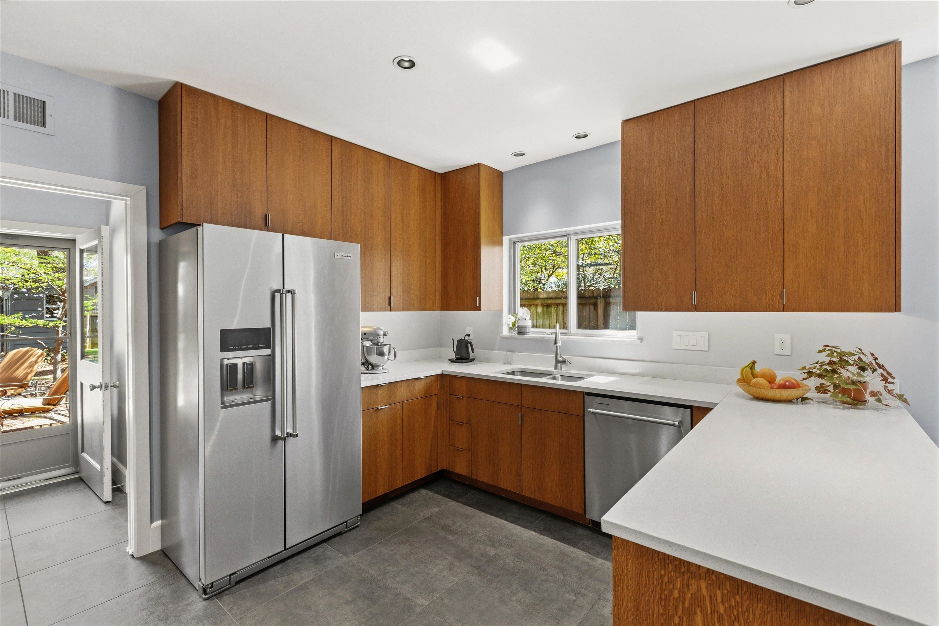 140 South Grove Park Road Memphis, TN 38117 - Photo 15 of 40 Kitchen with stainless steel appliances, wood finish cabinets, light countertops, dark tile patterned flooring, and recessed lighting