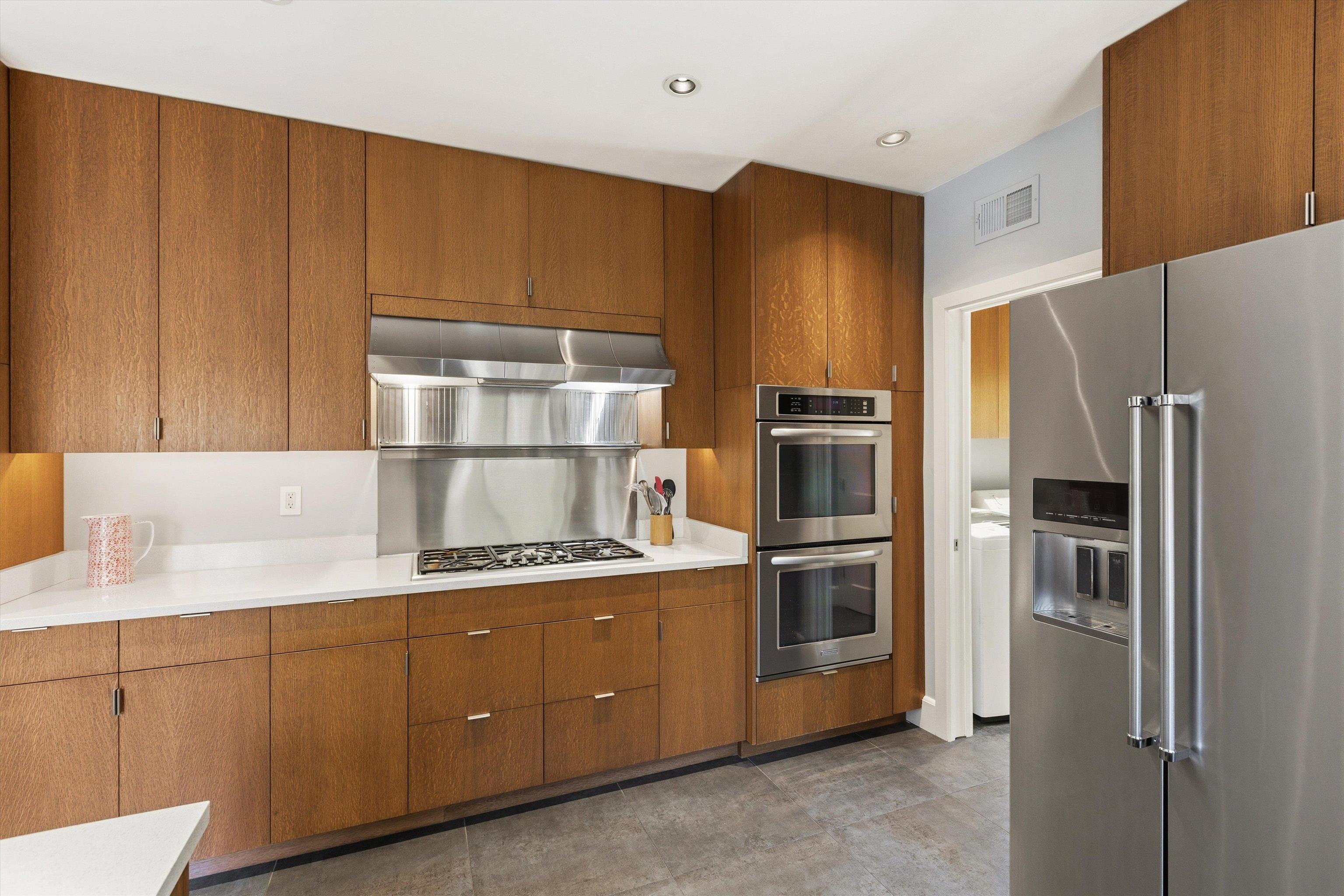 140 South Grove Park Road Memphis, TN 38117 - Photo 16 of 40 Kitchen with stainless steel appliances, light countertops, wood finish cabinets, ventilation hood, and recessed lighting