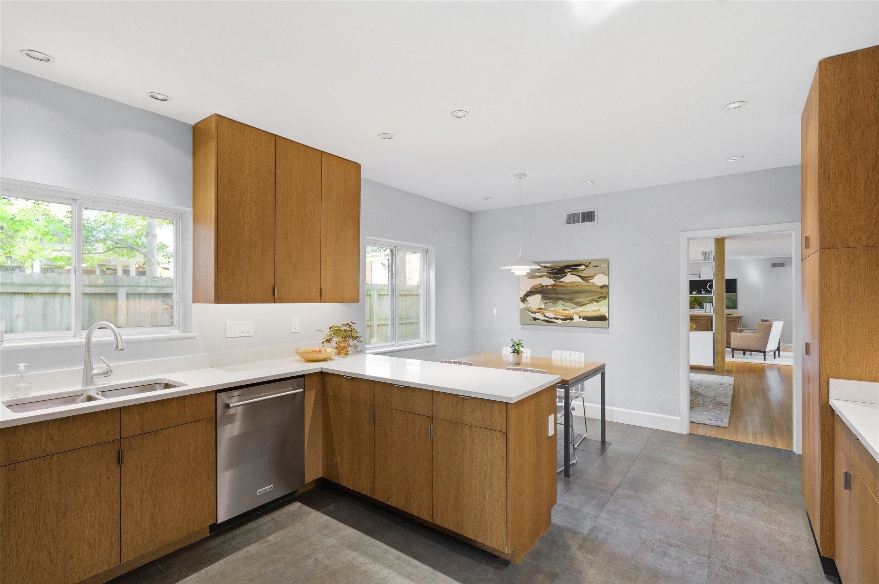 140 South Grove Park Road Memphis, TN 38117 - Photo 18 of 40 Kitchen featuring wood finish cabinets, a peninsula, pendant lighting, dishwasher, and concrete flooring