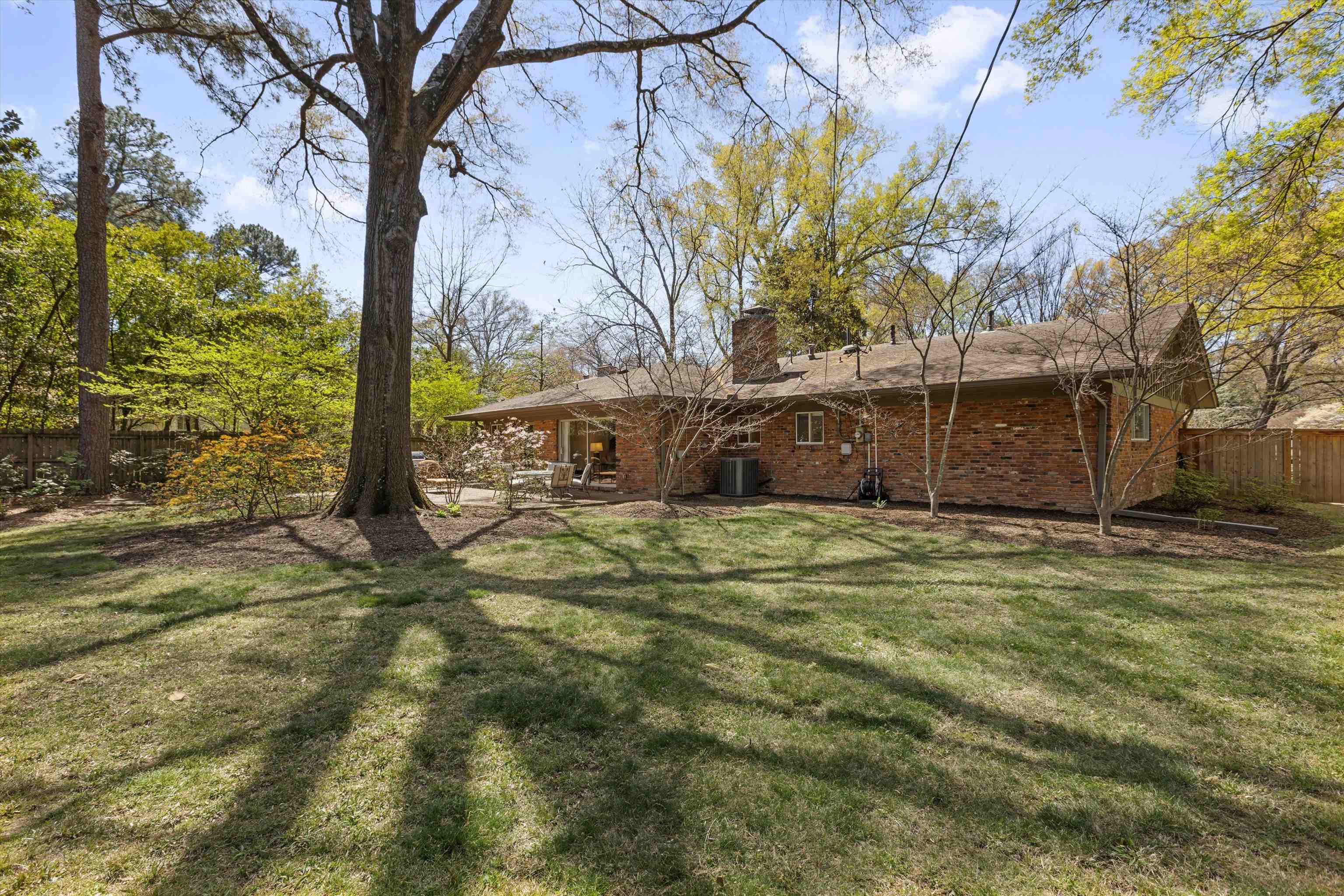 140 South Grove Park Road Memphis, TN 38117 - Photo 39 of 40 Back of property with brick siding, a patio, and a chimney