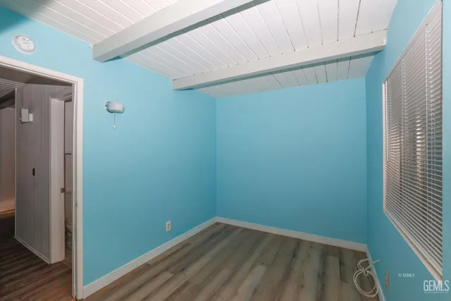 a small space with wooden floor and a window