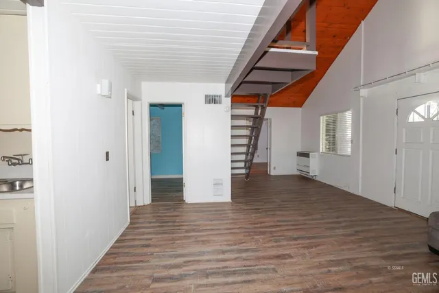 a view of an entryway with wooden floor