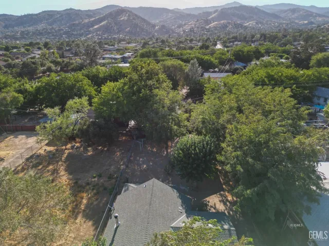 an aerial view of a house with a yard