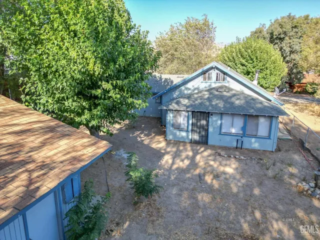 a view of a wooden house with a yard