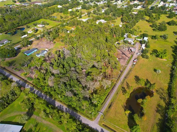 a view of swimming pool with a lot of flowers and trees around