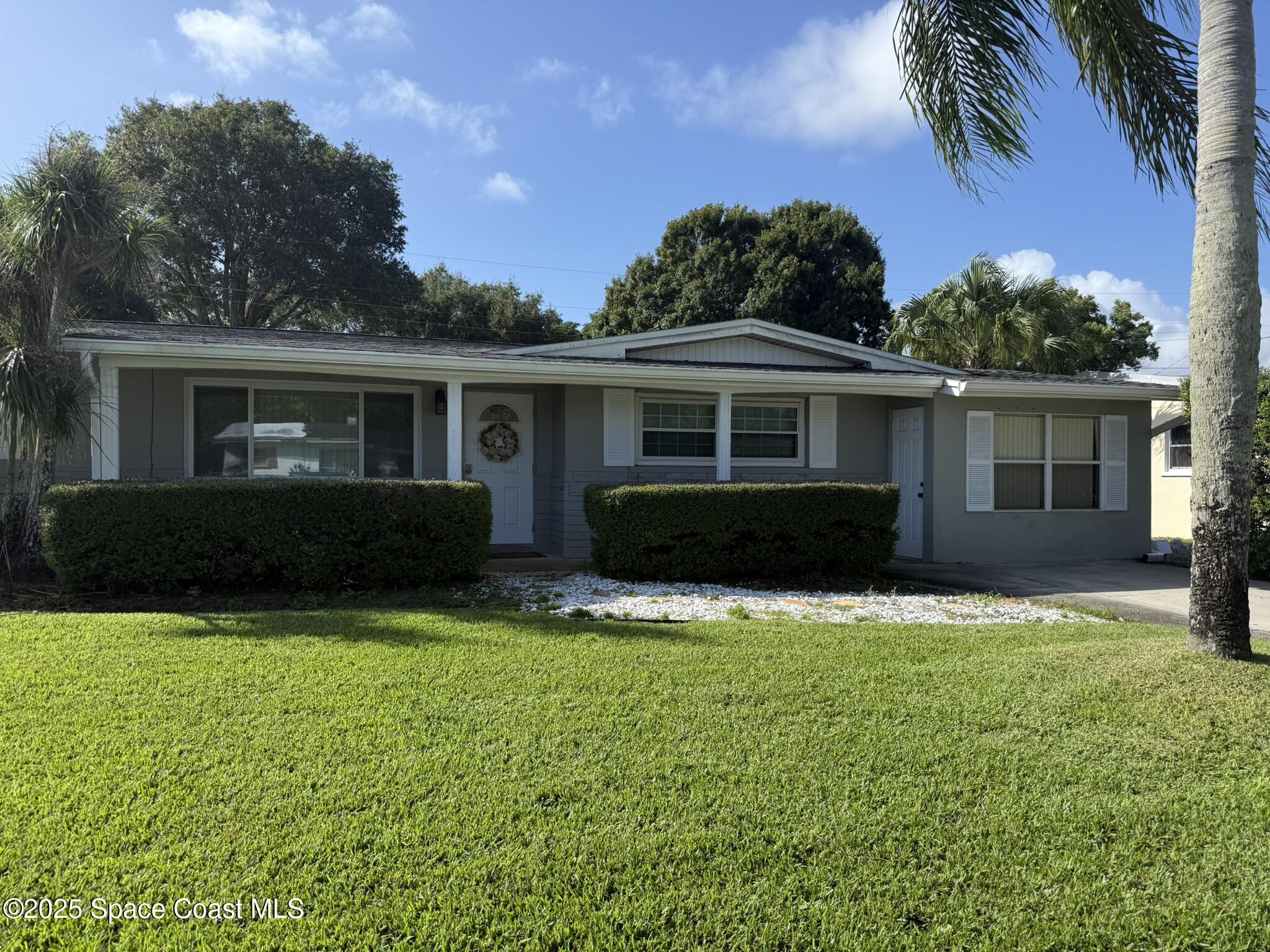 a front view of house with yard and green space
