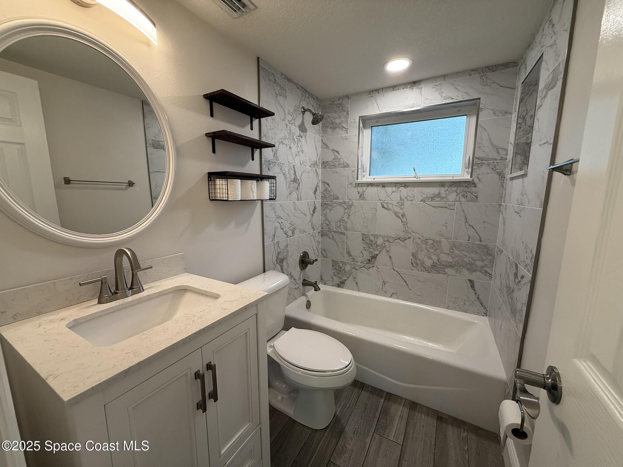 2801 Lorna Drive Melbourne, FL 32935 - Photo 12 of 25 a bathroom with a sink toilet and shower