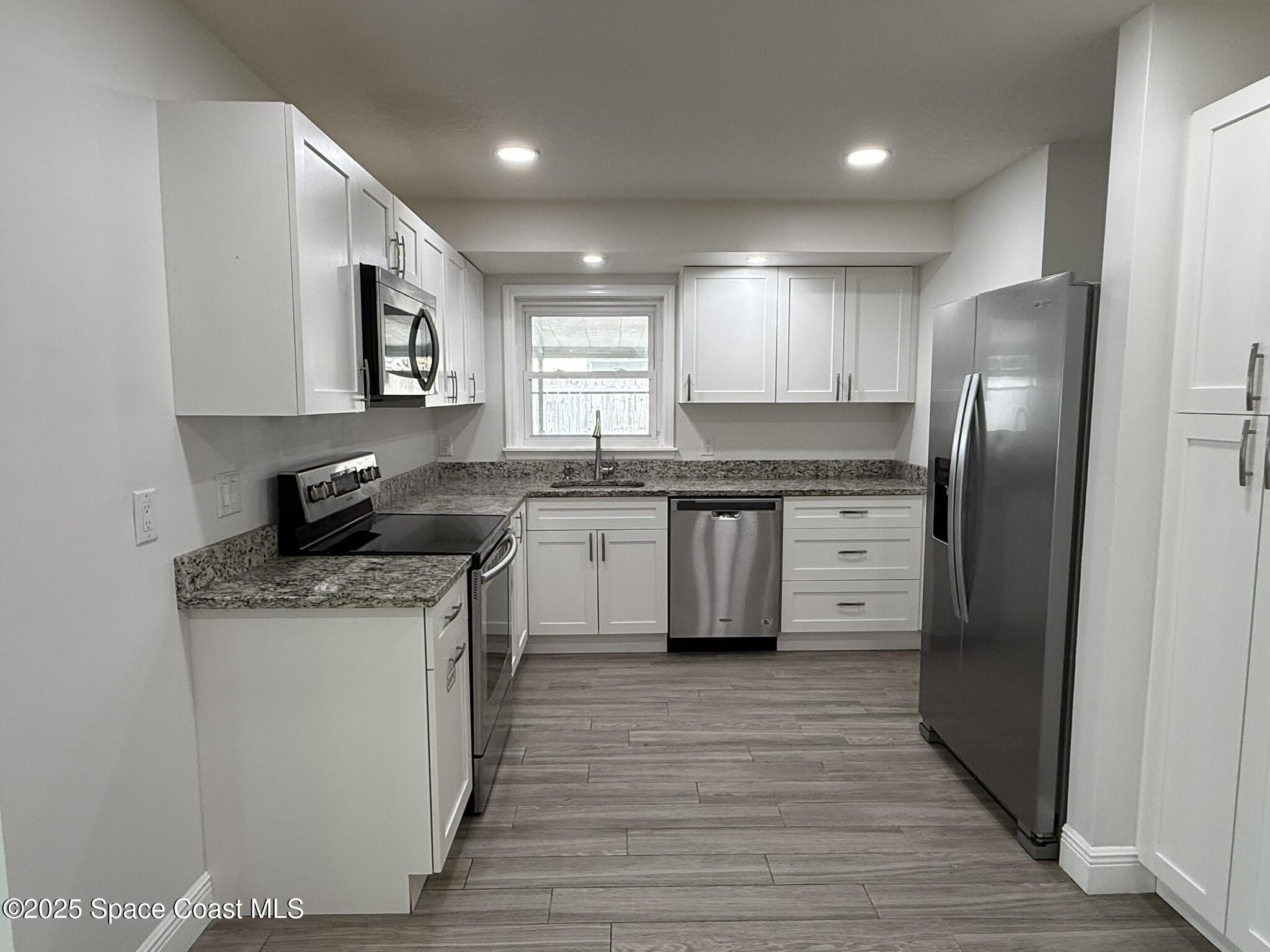 2801 Lorna Drive Melbourne, FL 32935 - Photo 16 of 25 a kitchen with stainless steel appliances granite countertop a sink stove and refrigerator