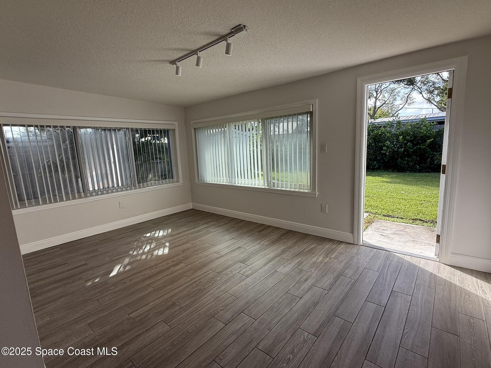 2801 Lorna Drive Melbourne, FL 32935 - Photo 18 of 25 a view of an empty room with wooden floor and a window