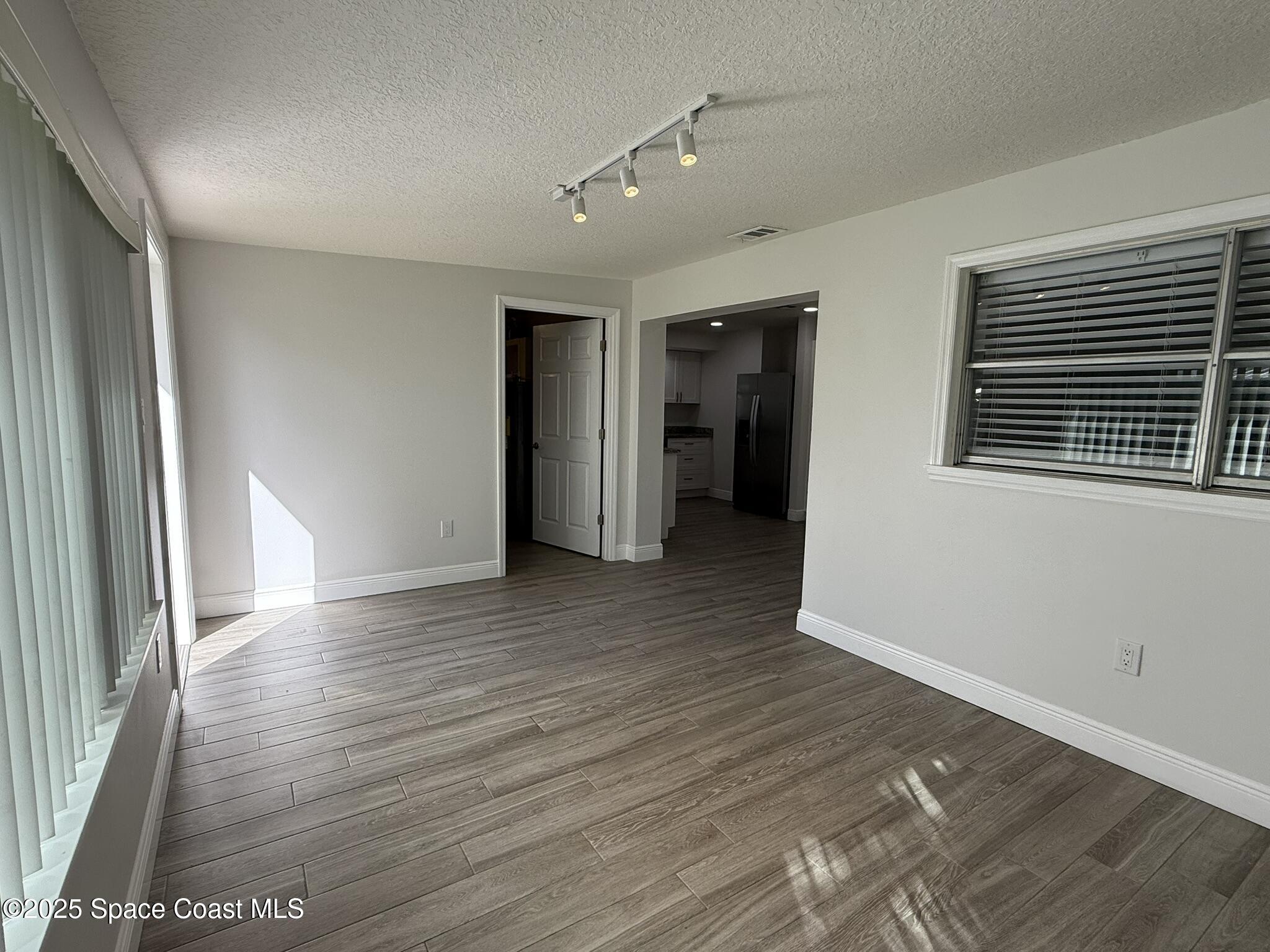 2801 Lorna Drive Melbourne, FL 32935 - Photo 19 of 25 a view of an empty room with wooden floor and a window