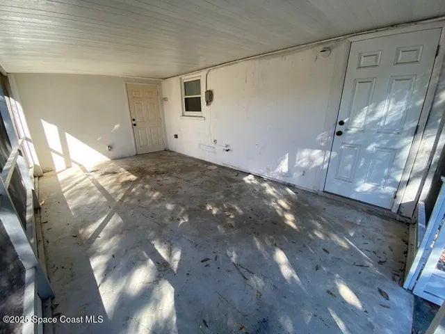 a view of a backyard with plants and a patio