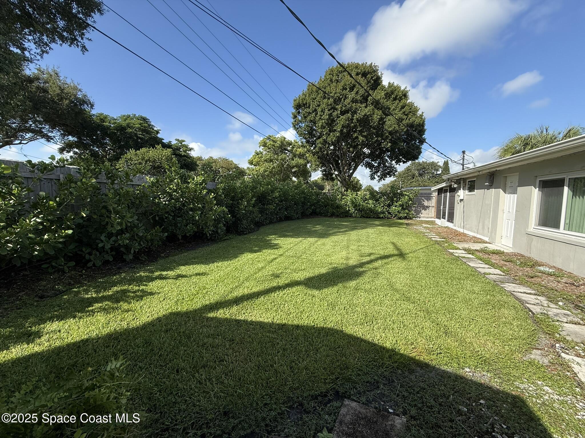 2801 Lorna Drive Melbourne, FL 32935 - Photo 23 of 25 a view of a backyard with plants and a patio