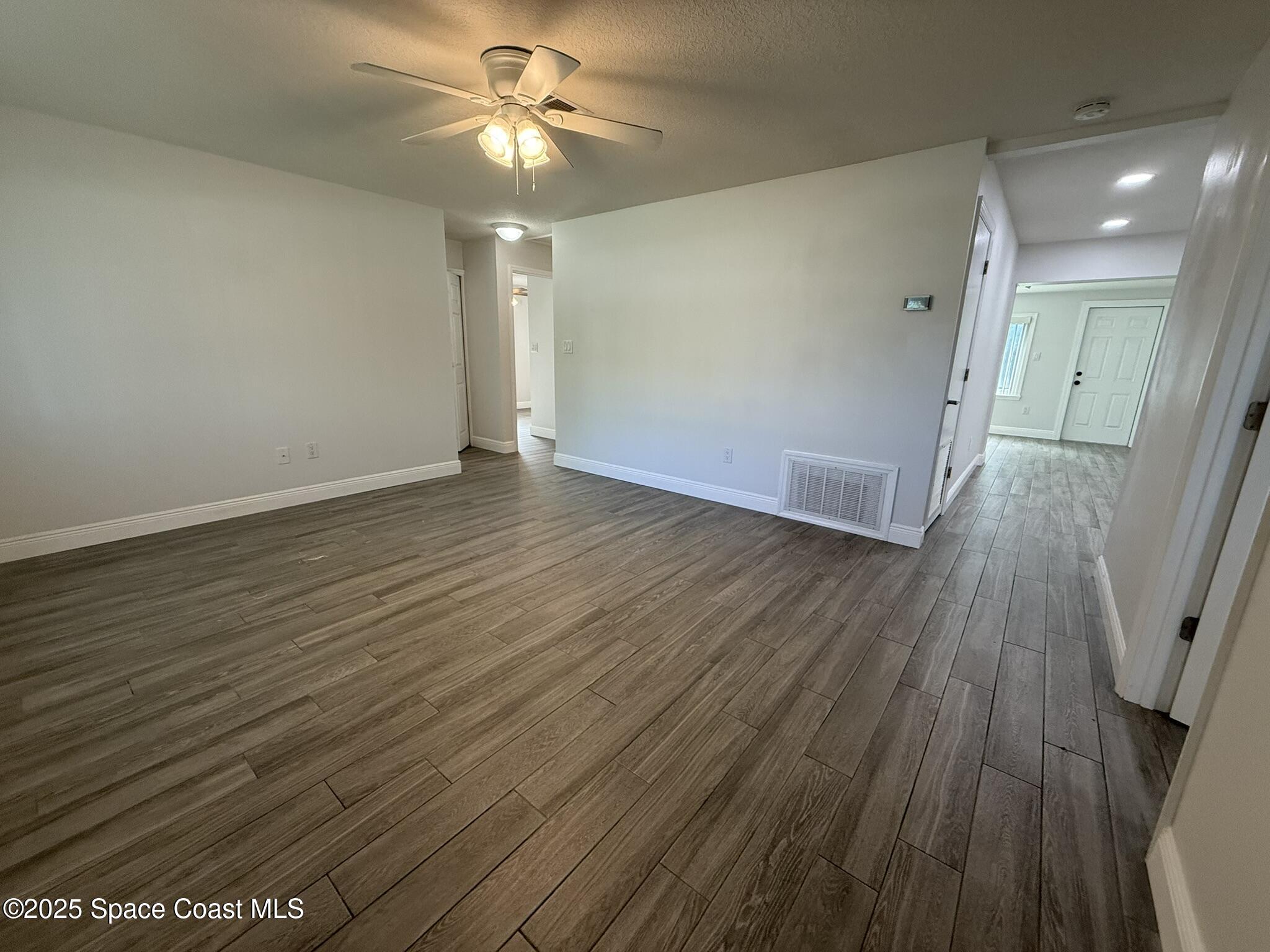 2801 Lorna Drive Melbourne, FL 32935 - Photo 3 of 25 wooden floor in an empty room with a window