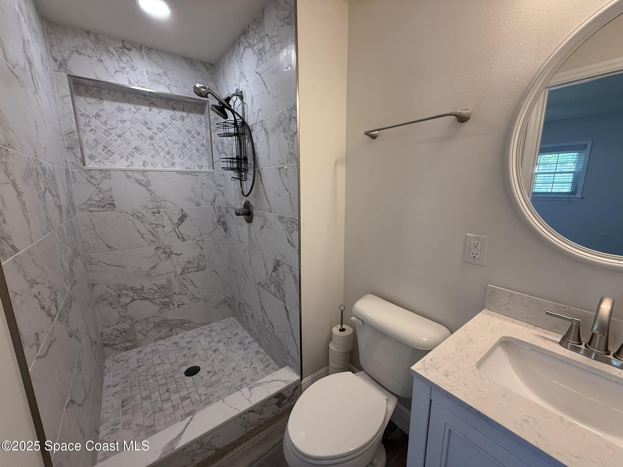 2801 Lorna Drive Melbourne, FL 32935 - Photo 7 of 25 a bathroom with a sink toilet and shower