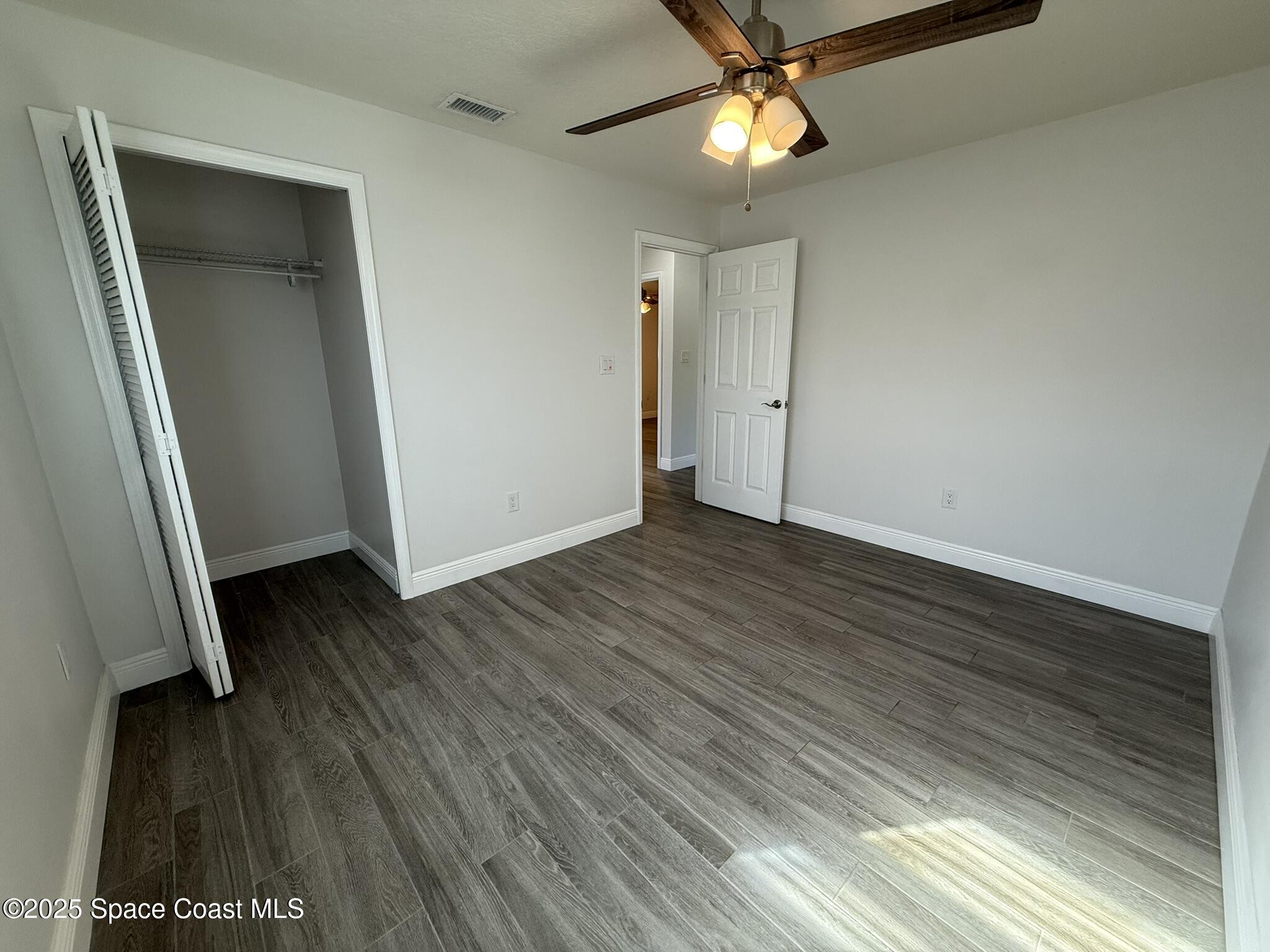 2801 Lorna Drive Melbourne, FL 32935 - Photo 9 of 25 wooden floor in an empty room with a window