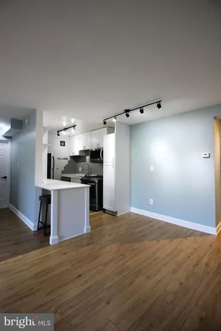 a kitchen with stainless steel appliances kitchen island granite countertop a refrigerator and a stove top oven