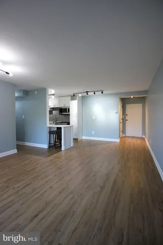 a view of empty room with wooden floor