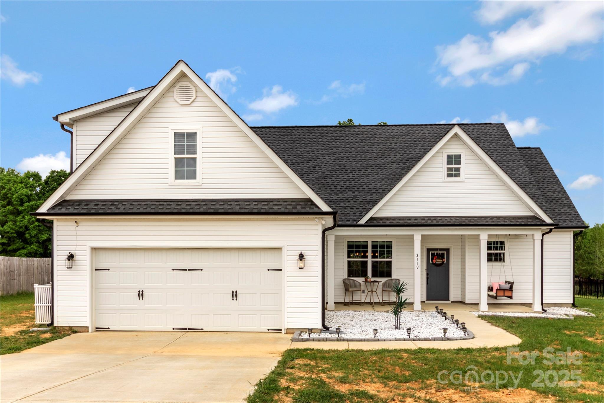 2119 State Rd S-46-1474 Clover, SC 29710 - Photo 3 of 25 a front view of a house with a yard outdoor seating and garage