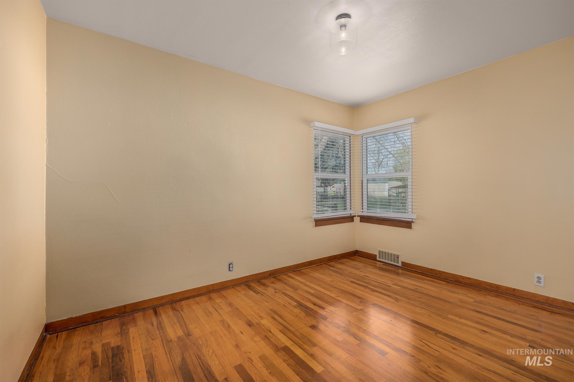 1016 West 5th Street Weiser, ID 83672 - Photo 14 of 36 Empty room with baseboards and light wood-style floors