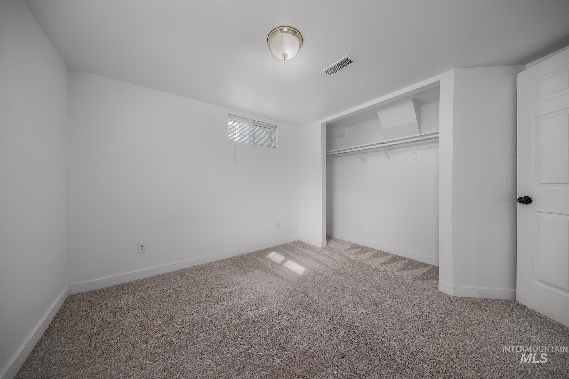 1016 West 5th Street Weiser, ID 83672 - Photo 20 of 36 Unfurnished bedroom with carpet floors and a closet