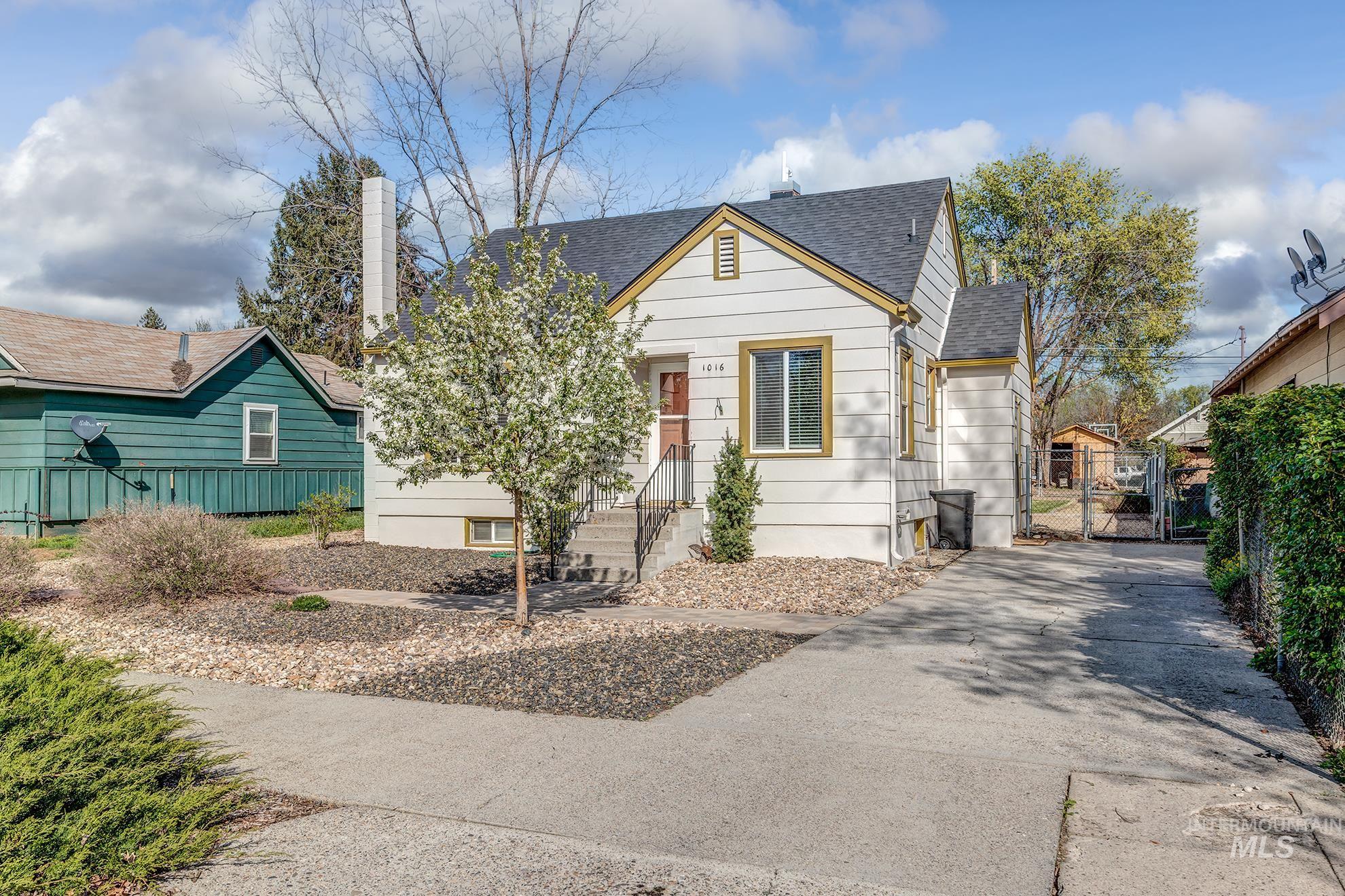 1016 West 5th Street Weiser, ID 83672 - Photo 34 of 36 Bungalow featuring a shingled roof, a gate, a chimney, and driveway