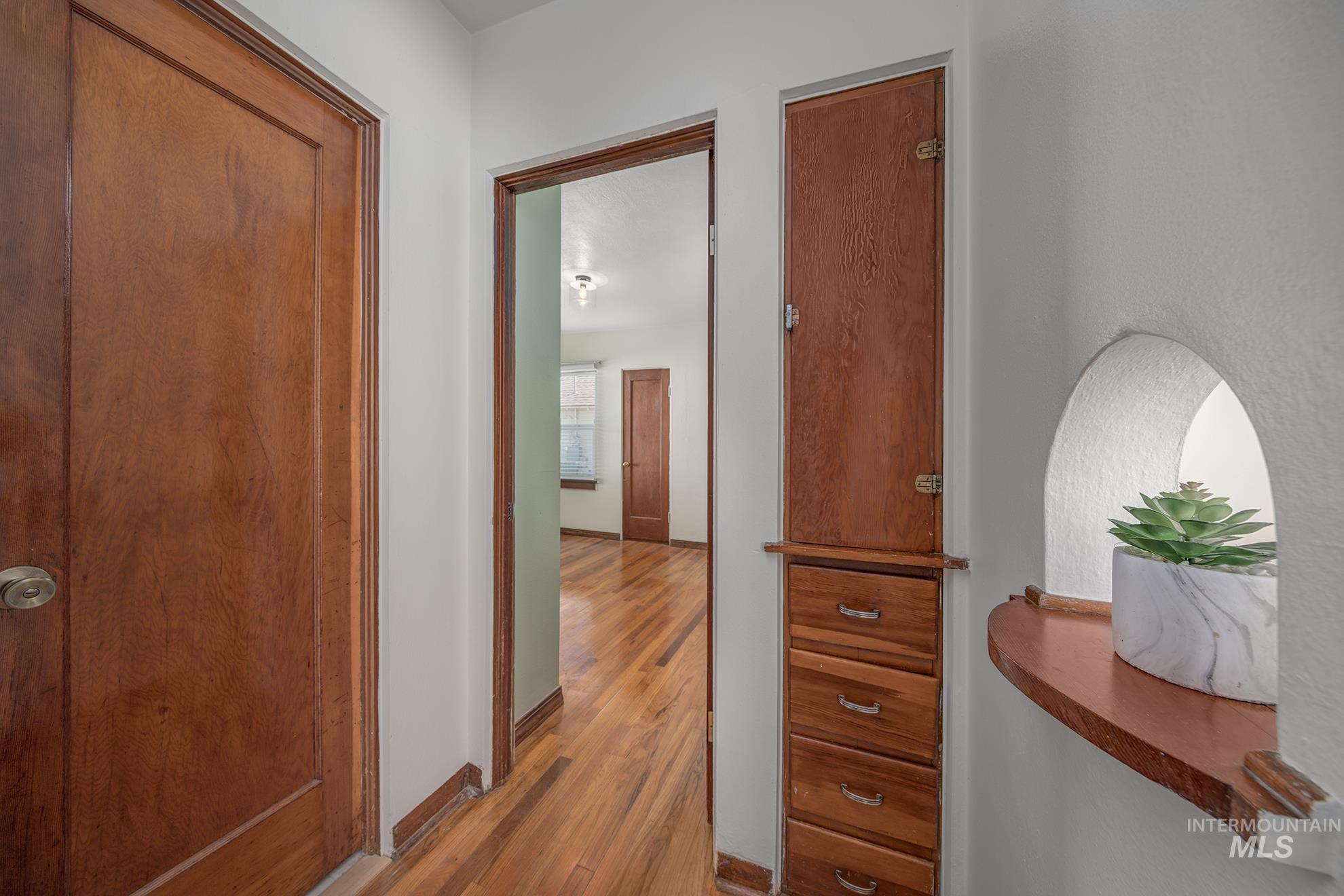 1016 West 5th Street Weiser, ID 83672 - Photo 10 of 36 Hallway featuring light wood finished floors and baseboards