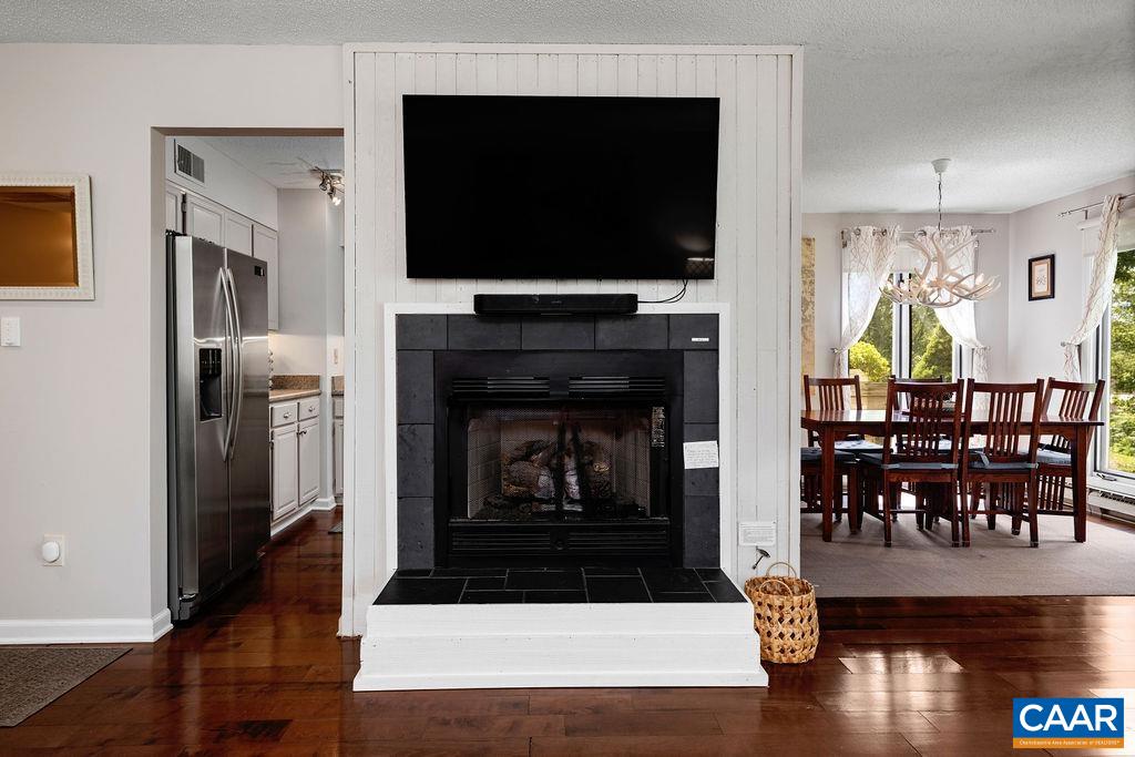 Gas logs fireplace in the living room with the propane provided by the condo HOA.