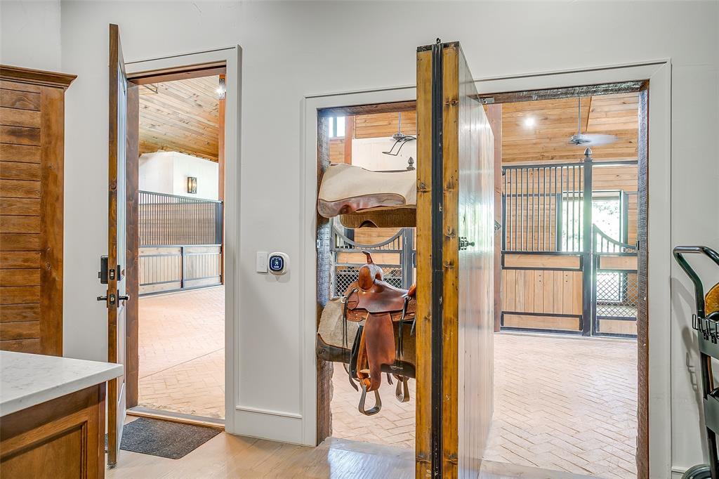 5000 T W King Road Southlake, TX 76092 - Photo 14 of 40 Tack room with custom moving island and rotating tack room wall.