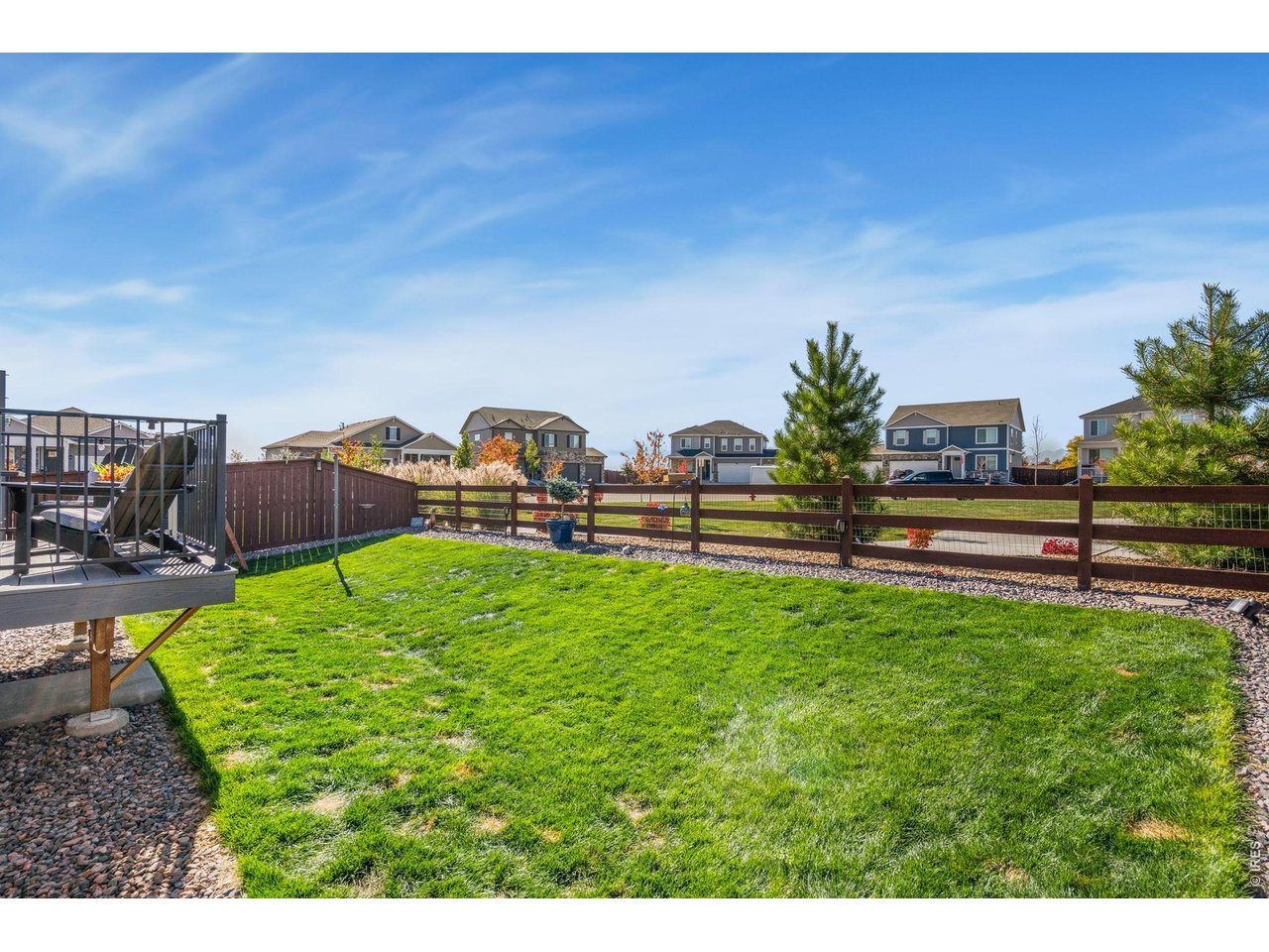 438 Bluebird Road Johnstown, CO 80534 - Photo 30 of 33 Fully fenced yard backing to open space with Front Range mountain views and trail access at the fence line.