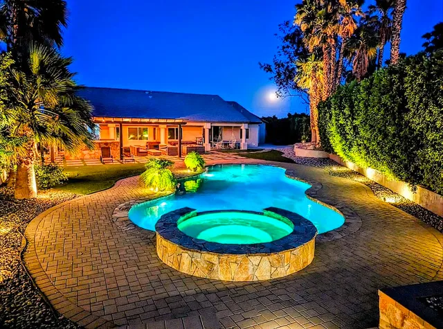 a view of a swimming pool with an outdoor space and seating area
