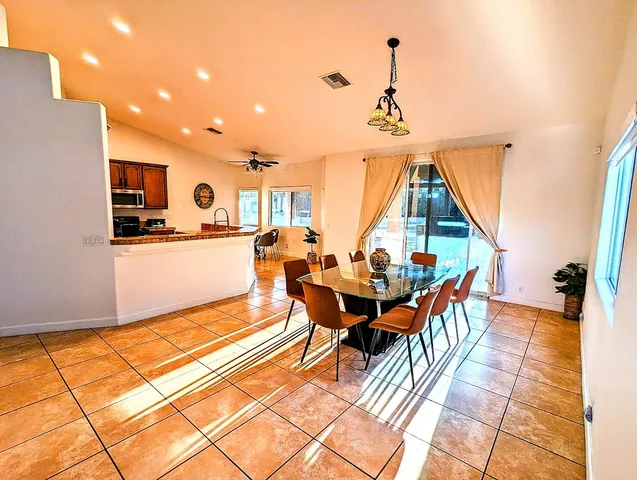 a dining room with furniture and a chandelier