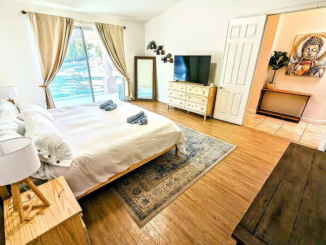 a bedroom with a bed and flat screen tv