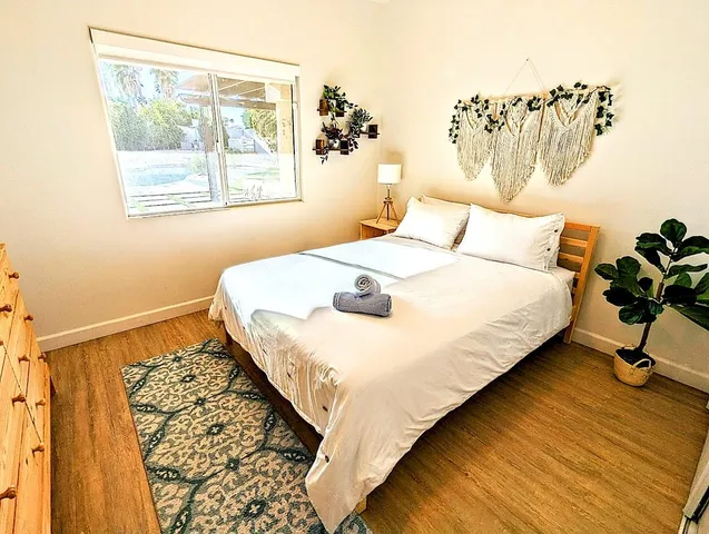 a bedroom with a bed and a window