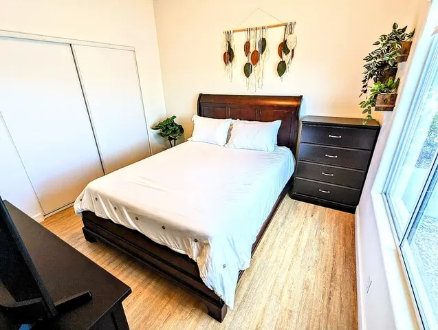 a bedroom with a bed and a mirror