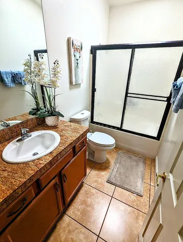 a bathroom with a sink toilet and mirror